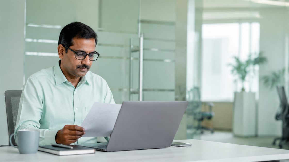 An insurance team reviewing digital claim documents on screen.